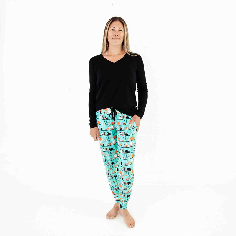 Woman wearing black and teal Halloween pajamas. 