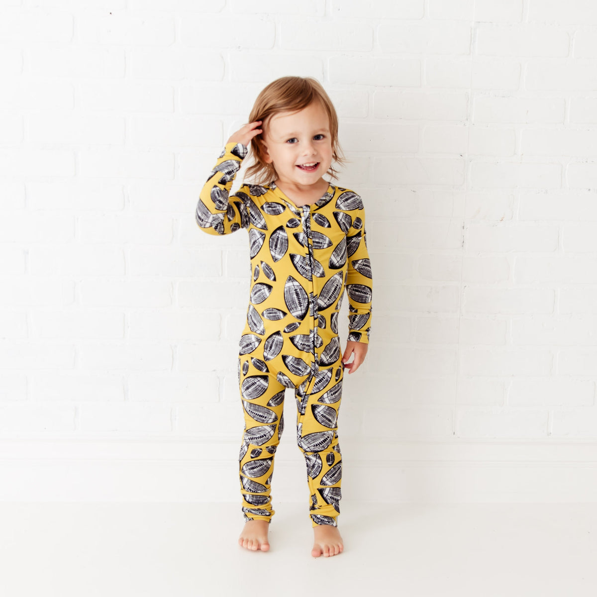 Convertible baby footie with football-themed print from Dreamiere