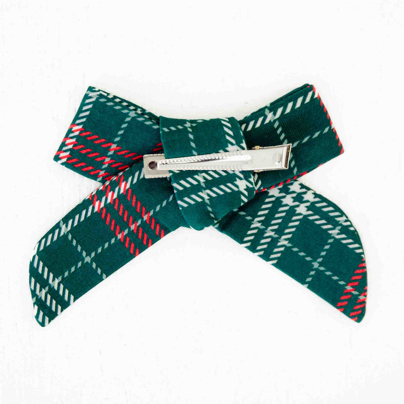 Back and clip of a plaid hair bow. 