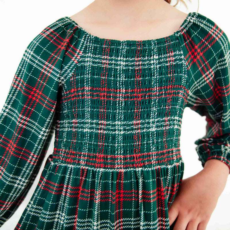 Close-up of holiday plaid smocked dress.