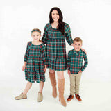 Mom and kids in matching holiday outfits.