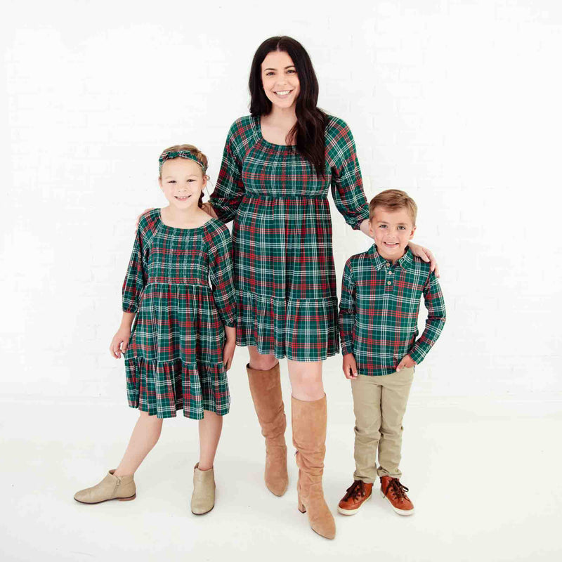 Mom and kids in matching holiday outfits.