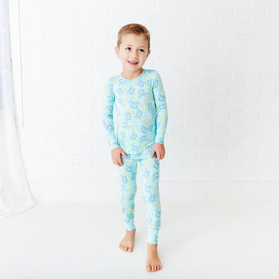 Smiling baby wearing colorful printed pajamas from Dreamiere