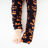 Feet showing convertible Halloween  footie pajamas. 