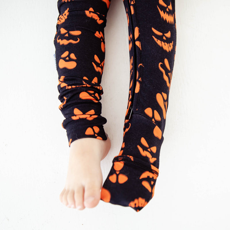 Feet showing convertible Halloween  footie pajamas. 