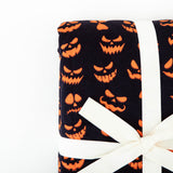 Corner of a folded jack-o-lantern blanket. 