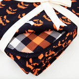 Corner of reversible halloween themed blanket. 