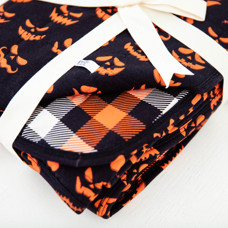 Corner of reversible halloween themed blanket. 