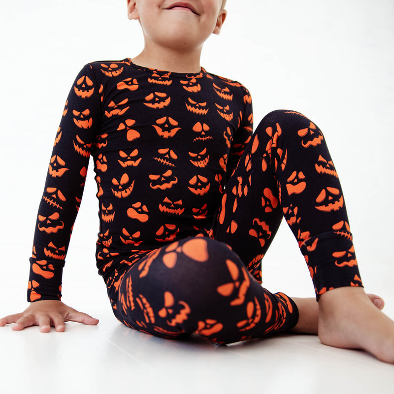 Child wearing halloween themed pajamas. 