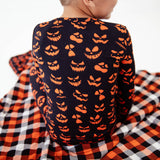Close-up of jack-o-lantern pajamas on boy. 