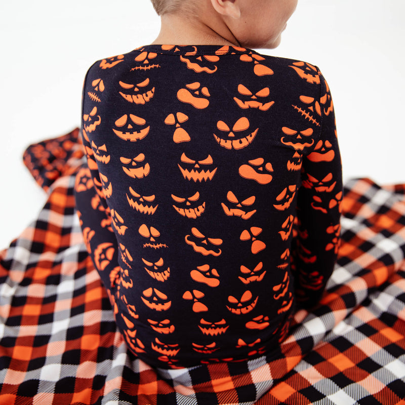 Close-up of jack-o-lantern pajamas on boy. 