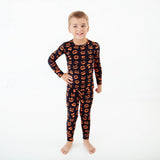 Child wearing jack-o-lantern pajamas. 