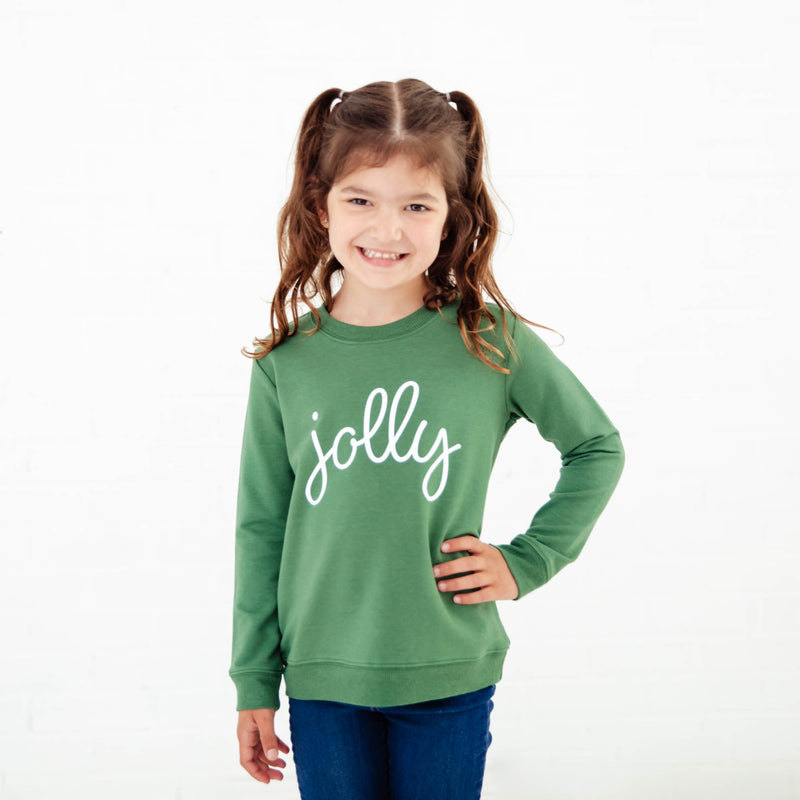 Girl wearing Green Jolly sweatshirt. 