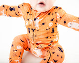 Close up of orange halloween print pajamas.