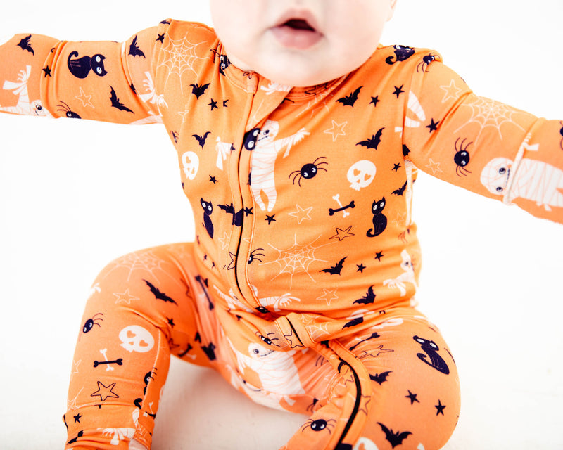 Close up of orange halloween print pajamas.