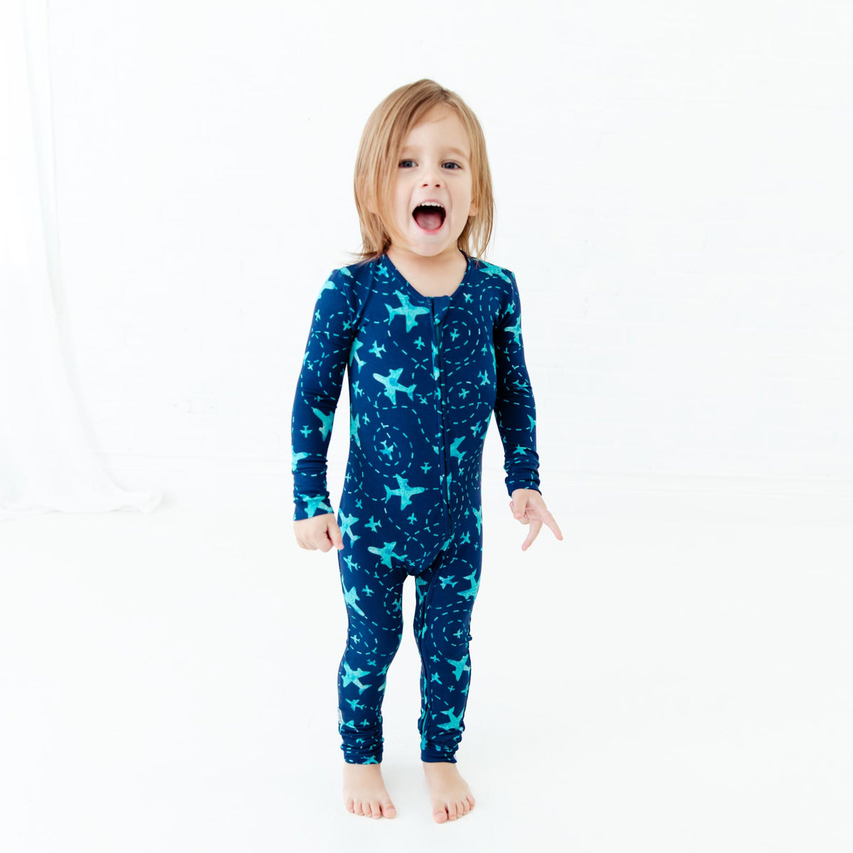 Convertible baby footie with navy airplane print by Dreamiere