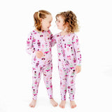 Two girls wearing matching nutcracker pajamas. 