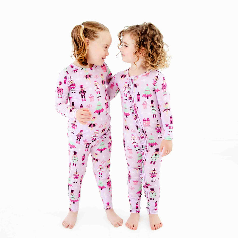 Two girls wearing matching nutcracker pajamas. 