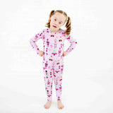 Girl wearing purple and pink nutcracker holiday pajamas. 