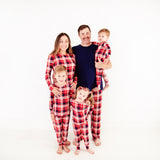 Family wearing matching red plaid pajamas.