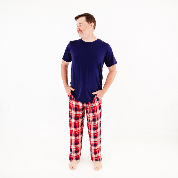 Man wearing red plaid pajamas with blue shirt. 
