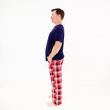 Man wearing a navy t-shirt and red plaid pajama.