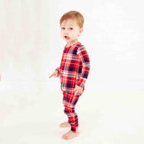Child wearing red Holiday pajamas. 