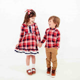 Children wearing coordinating holiday outfits.