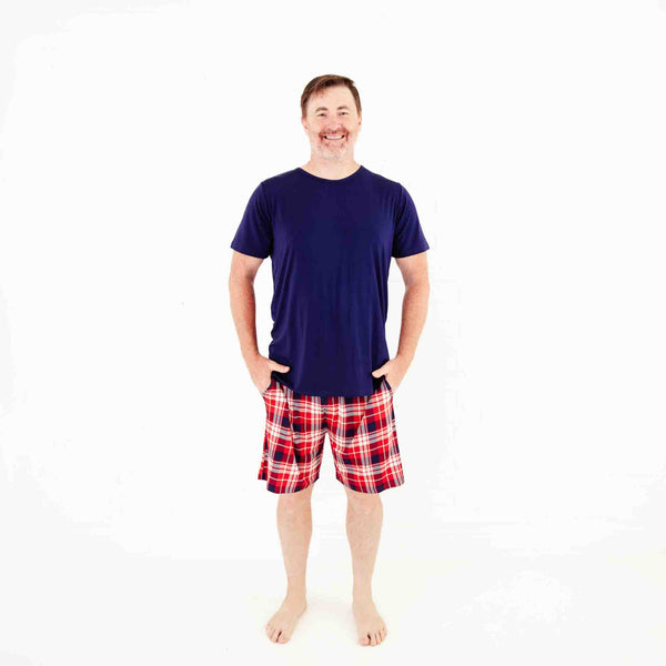 Man in a plaid shorts pajamas set. 