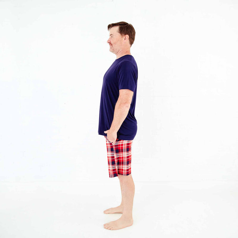 Man wearing red plaid short pajamas.
