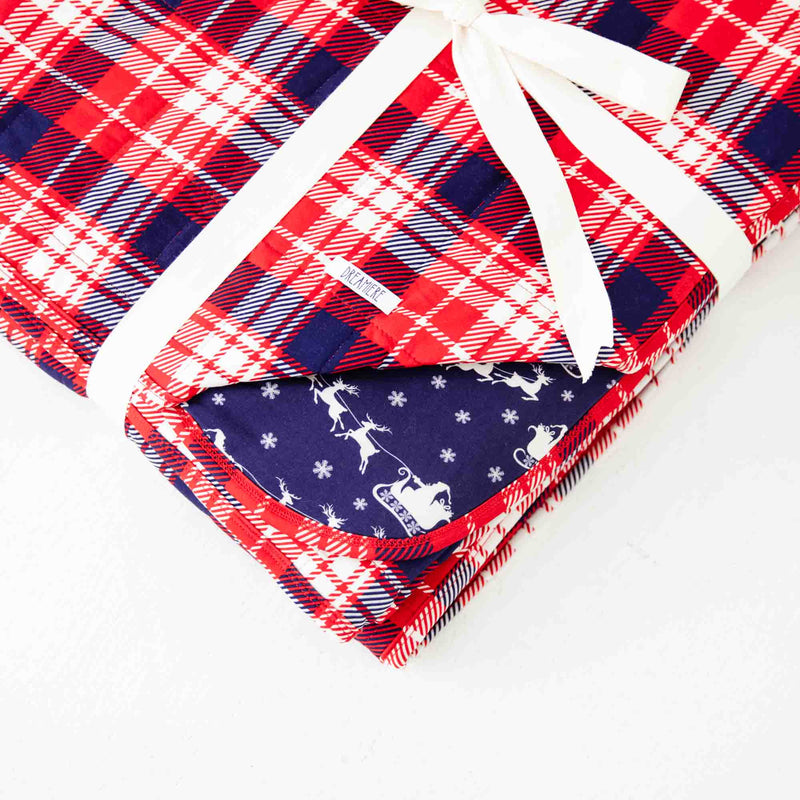 Folded reversible holiday blanket. 