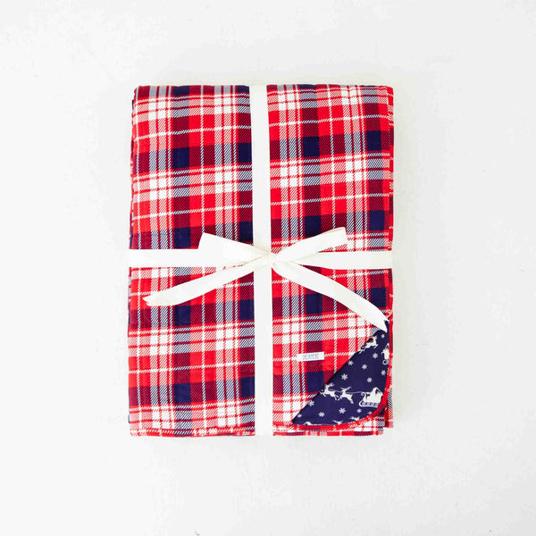 Folded red plaid bamboo blanket . 
