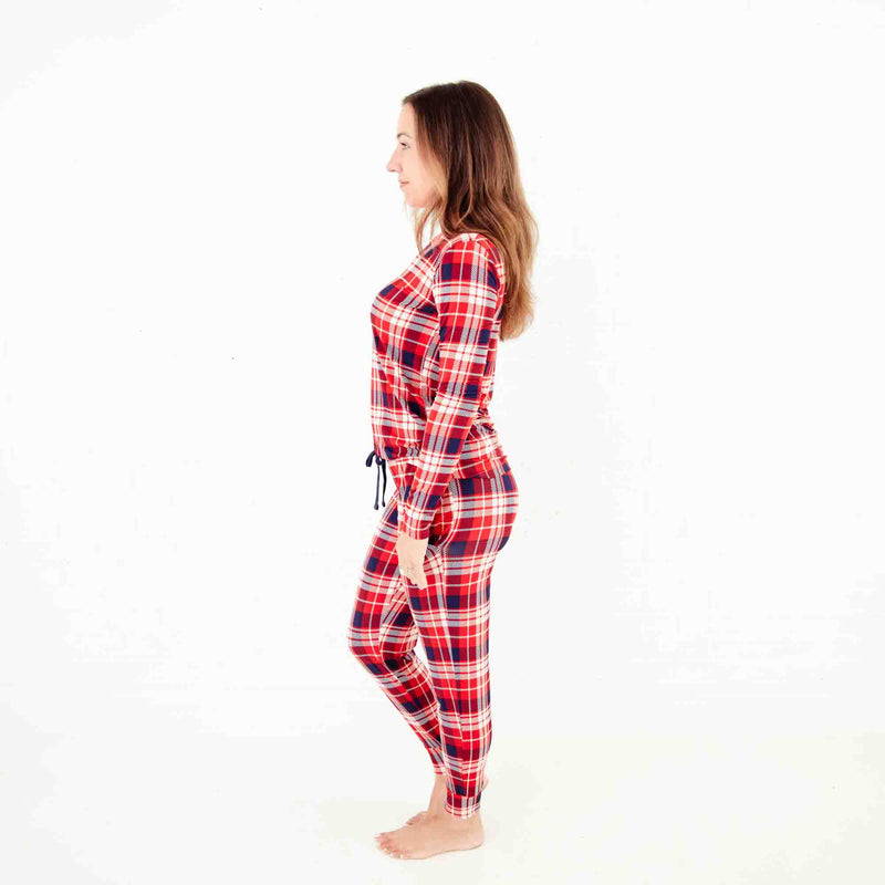 Woman wearing a red and blue plaid pajamas. 