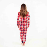 Woman wearing red plaid pajamas. 