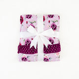 Folded blanket with rose print. 
