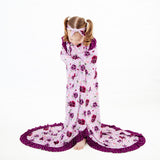 Child wrapped in a floral bamboo blanket.