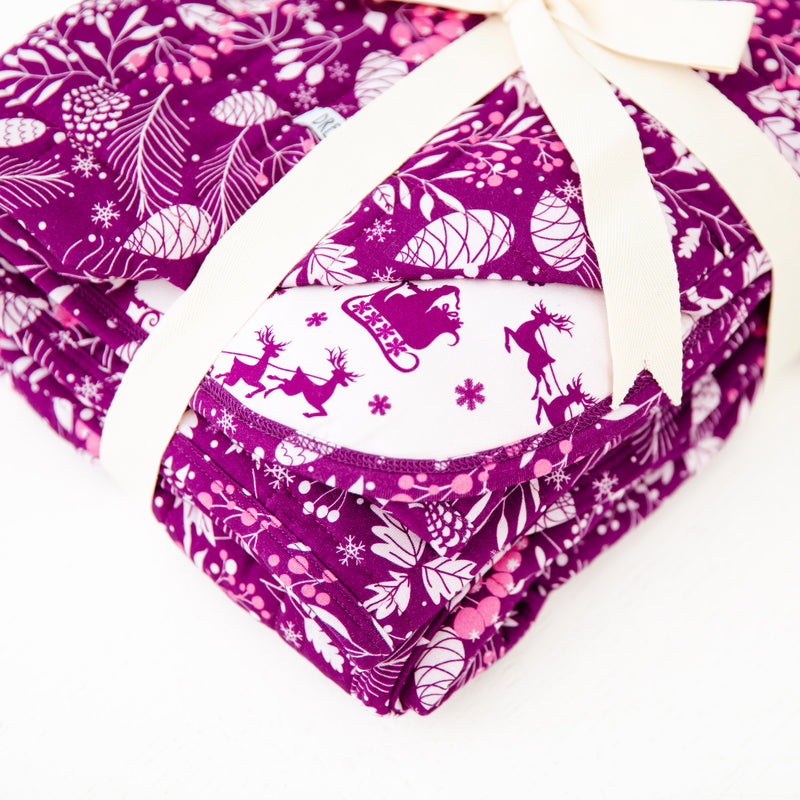 Purple floral blanket with santa's sleigh background.