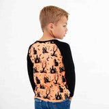 Child wearing an orange and black Halloween themed shirt. 