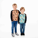 Two children wearing Halloween-themed raglan shirts.