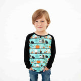 Child wearing a teal Halloween-themed shirt.