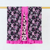 Ruffle reversible blanket with spooky floral print.