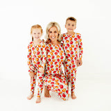 Woman and children in matching fall pajamas.