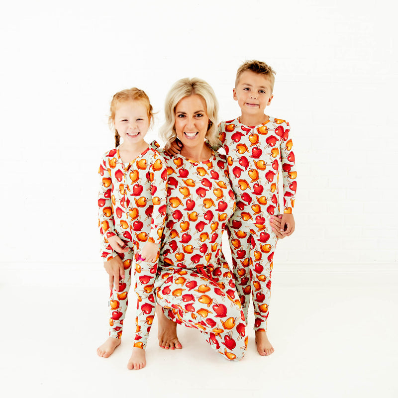 Woman and children in matching fall pajamas.