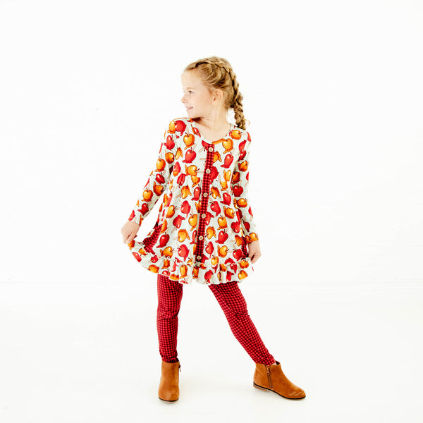 Girl wearing a fall tunic and leggings set. 