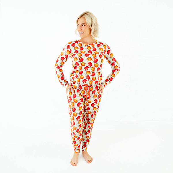Woman wearing pajamas with caramel apple print.