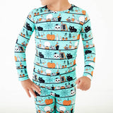 Close-up of teal Halloween print pajamas. 