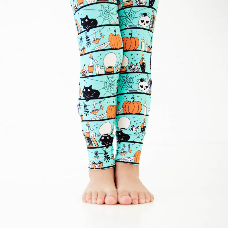 Child's legs showing Halloween theme pajamas. 