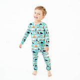 Boy wearing teal halloween themed pajamas. 