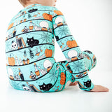 Close-up of teal Halloween themed pajamas. 
