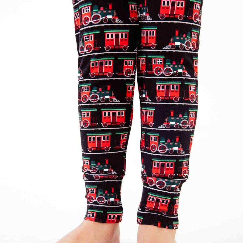 Legs showing train print detail on pajamas. 